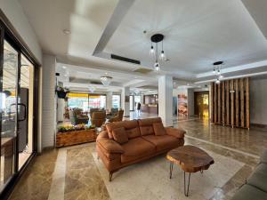 a living room with a brown couch and a table at Villa Vanilla Hotel in Istanbul