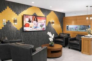 a waiting room with chairs and a tv on a wall at Quality Inn Conference Center Logansport in Logansport