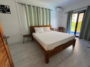a bedroom with a bed and a large window at Authentica Private Villa by Oceanaxe Holidays in Calodyne +33 photos