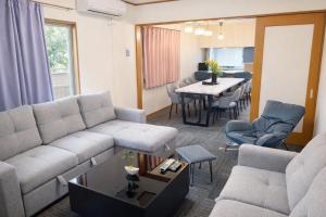 a living room with a couch and a table at HORIKIRI House TOKYO in Tokyo