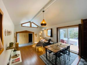 a living room with a table and a couch at Spa - River & Forest View - Le Petit Cocon in Chateau Richer