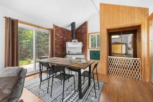 a kitchen with a table and chairs in a room at Spa - River & Forest View - Le Petit Cocon in Chateau Richer