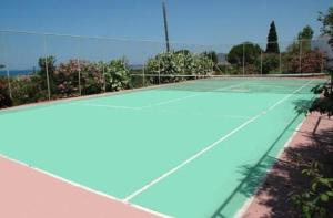 a tennis court with a tennis court at Hotel Navarone in Petrochori