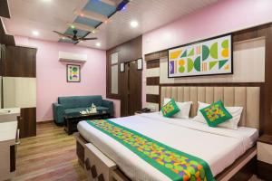 a bedroom with a bed and a chair in it at Treebo Saumendra Residency in Varanasi