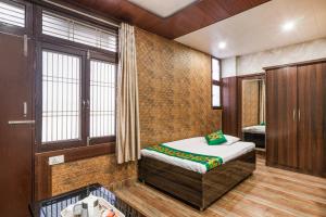 a bedroom with a bed in a room at Treebo Saumendra Residency in Varanasi