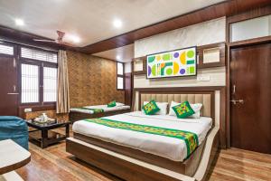 a hotel room with a bed and a couch at Treebo Saumendra Residency in Varanasi