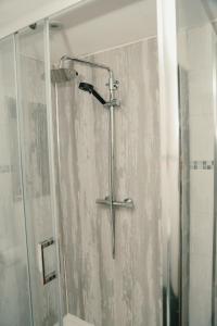 a shower with a glass door in a bathroom at The Phoenix in Swansea +24 photos