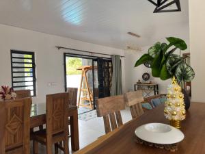 a dining room and living room with a table and chairs at Authentica Private Villa by Oceanaxe Holidays in Calodyne