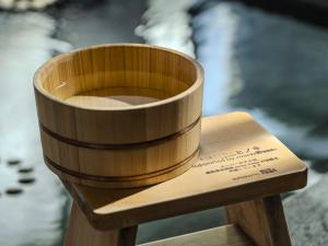 a wooden cup sitting on top of a wooden table at Super Hotel Tottori Station North Exit Smoke-Free in Tottori