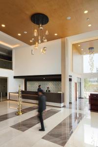 a man walking through the lobby of a building at Parays Fernwoods in Mannārakkāt +43 photos
