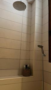 a shower with a shower head in a bathroom at Magdalena in Cospicua
