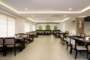 a dining room with tables and chairs in a restaurant at Parays Fernwoods in Mannārakkāt