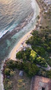 an aerial view of a beach and the ocean at Surf Lodge Madiha in Matara