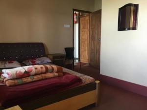 a living room with a couch and a table at Hotel Aditya in Aritar +1 photo