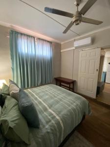 a bedroom with a bed and a ceiling fan at 22 Symmonds Studio in Melmoth +9 photos
