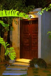 a wooden door with a bunch of bananas in front at Muraaya in Habaraduwa Central