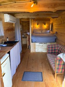a room with a bed and a couch in a cabin at Chicken roulotte des 3 cèdres in Cavaillon