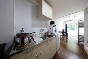 a kitchen with a sink and a counter top at Tsurumai Nagoya Stay in Nagoya