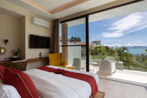 a bedroom with a bed and a view of the ocean at Luxury Sea View Jungle Beach Villa Walk to Beach in Ban Bang Po
