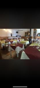 a dining room with tables and chairs in a restaurant at Agriturismo Cà da Nonna Rosa in Neirone