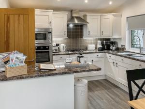 a kitchen with white cabinets and a counter top at 9 Trehawks in Roche