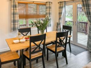 a dining room table with chairs and a wooden table at 9 Trehawks in Roche