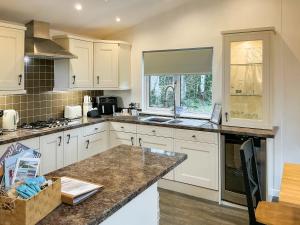 a kitchen with white cabinets and a counter top at 9 Trehawks in Roche +5 photos