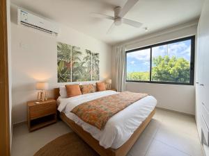 a bedroom with a bed and a large window at North Island View Family Duplex with private pool by LOV Mauritius in Grande Gaube +115 photos