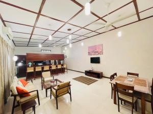 a large living room with a table and chairs at Barnes Loft Mount in Mount Lavinia