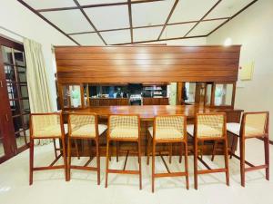 a dining room with a wooden table and chairs at Barnes Loft Mount in Mount Lavinia