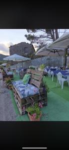 a group of chairs and tables and umbrellas at Agriturismo Cà da Nonna Rosa in Neirone
