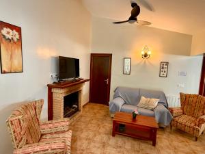 a living room with a couch and a fireplace at RAPIA Casa Beig 5 in Moratalla