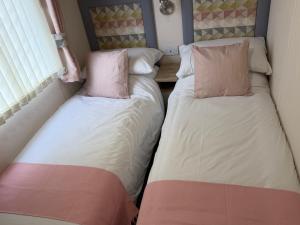 two beds sitting next to each other in a room at S&K Lodge Billing Aquadrome Holiday Park, Great billing ,Northampton , NN3 9DA in Northampton