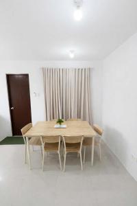 a wooden table and chairs in a room at Ben & Ben 1 in Cebu City