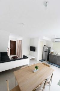 a living room with a table and a couch at Ben & Ben 1 in Cebu City