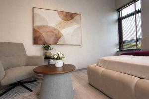 a living room with a bed and a couch and a table at Vantara Villa with Activity Ice Bath in Chiang Mai