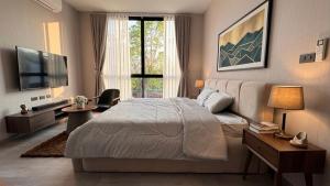 a bedroom with a large bed and a large window at Vantara Villa with Activity Ice Bath in Chiang Mai +18 photos