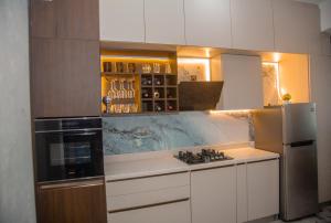 a kitchen with a stove and a refrigerator at Celenika Resort in Kandy +12 photos