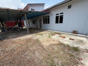 a white house with a large yard in front of it at Teratak Bonda in Temuh