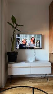 a flat screen tv on a wall in a living room at DreamerLux in Loznica