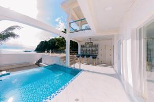 a pool in a house with a view of the ocean at Ezrah coastal boutique hotel el nido in El Nido +171 photos