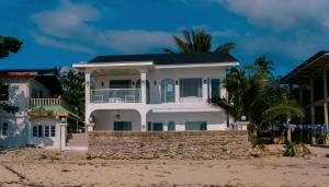 a large white house on the beach at Ezrah coastal boutique hotel el nido in El Nido