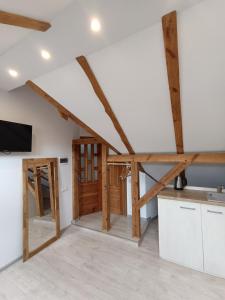 a kitchen with wooden beams in a attic at Vėtrungėlė in Nida
