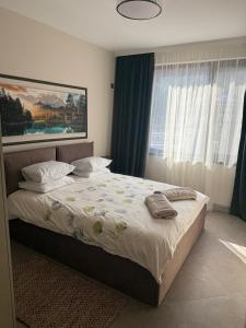 a bedroom with a large bed with pillows on it at Fresh SPA Relax Velingrad in Velingrad