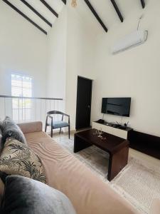 a living room with a couch and a coffee table at The Galene Villa By Celestial Ceylon in Negombo
