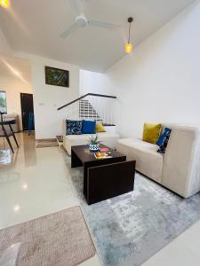 a living room with a couch and a coffee table at The Galene Villa By Celestial Ceylon in Negombo