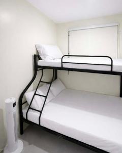a room with two bunk beds in a room at Ben & Ben 2 in Cebu
