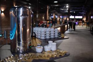 a table with cups and plates of food on display at Hotel AP in Kalisz