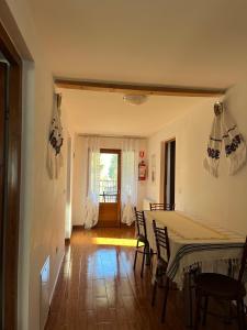 a dining room with a table and chairs at Cazare Luxandra in Borşa