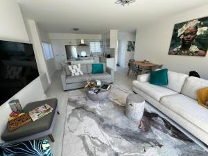 a living room with two couches and a table at Bayview Apartment in Timaru